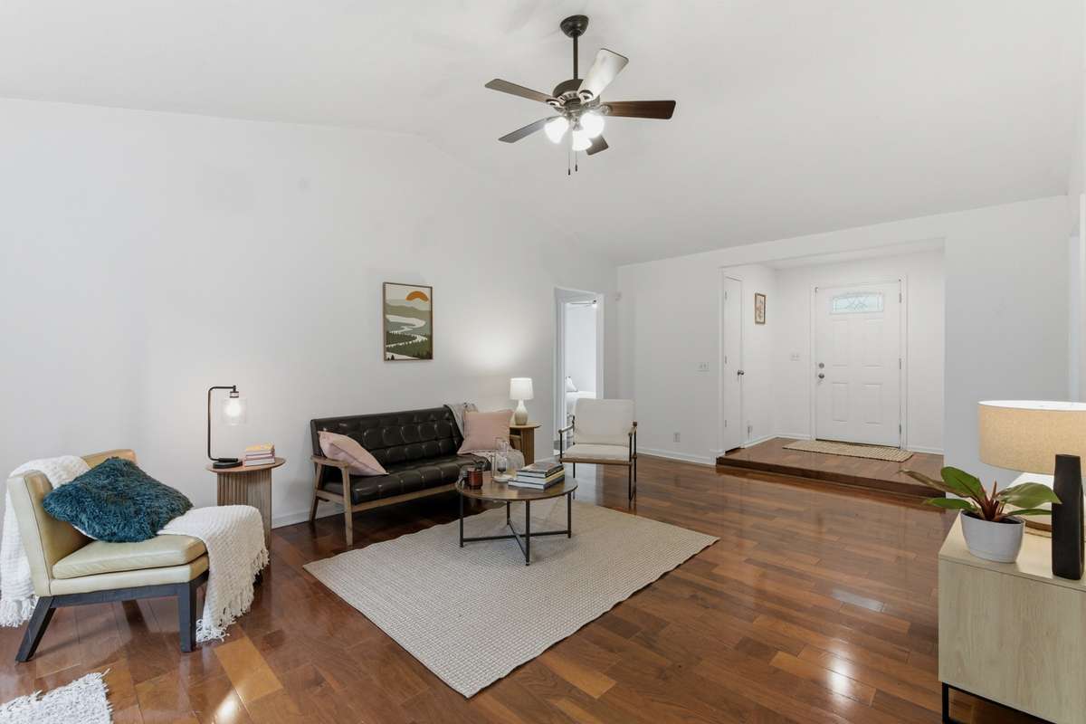 The hallway seen in this photo leads to the bedrooms and bathrooms.