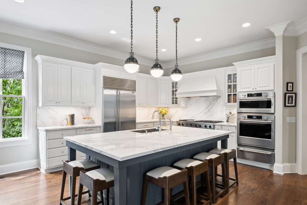 The spacious and bright Kitchen is a chef's dream with beautiful Neolith porcelain countertops, Viking 6 burner Gas range, SubZero refrigerator, Kitchen Aid Oven, Convection/Microwave and 2 dishwashers.