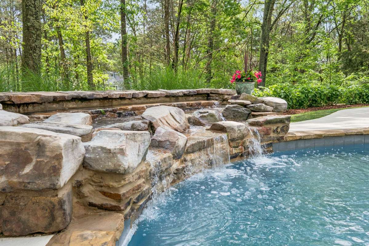 The soothing sound of the waterfall adds to the tranquil ambiance.