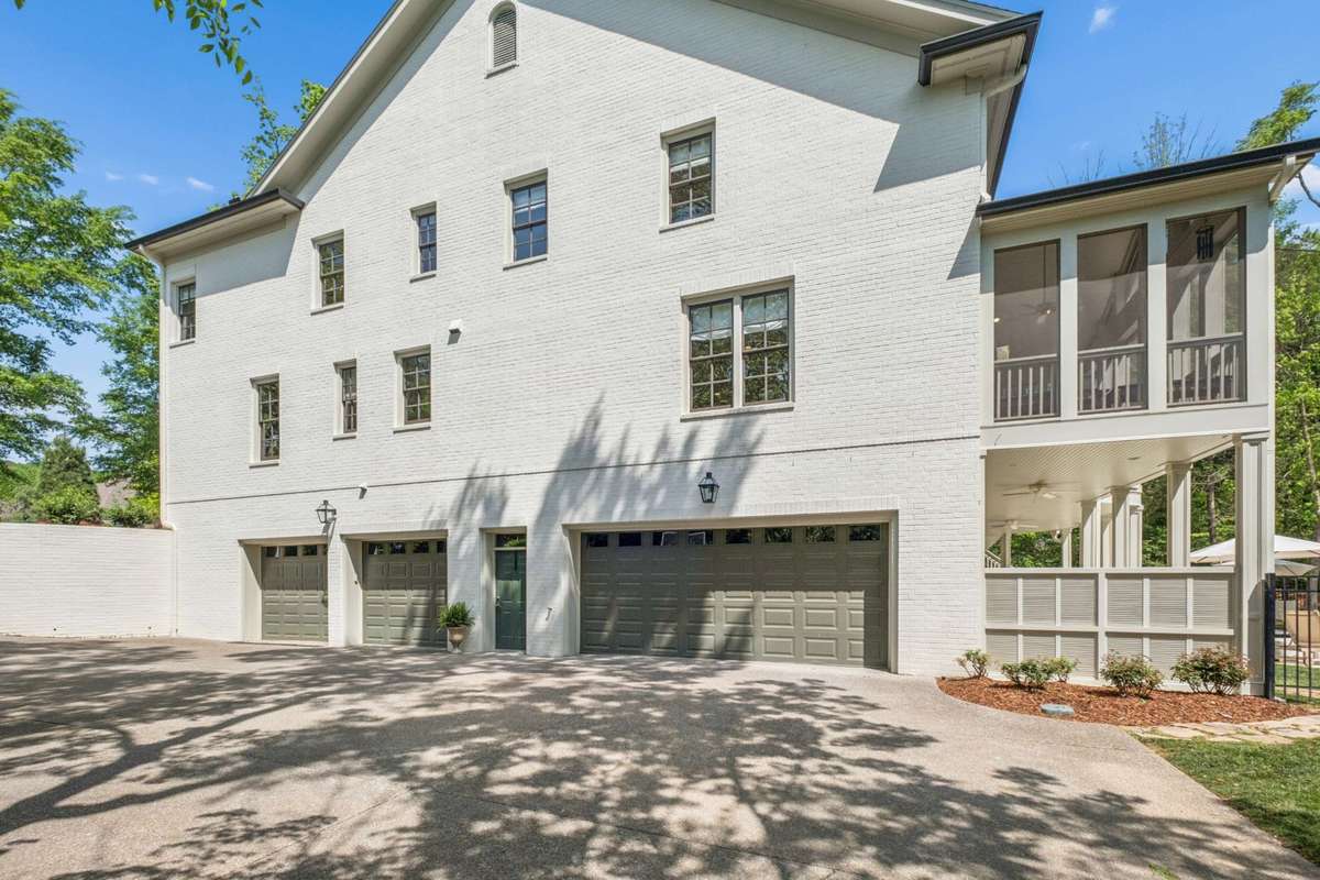 4 car garage with pedestrian door offers a clean, organized space for vehicles, bikes, sports equipment etc.