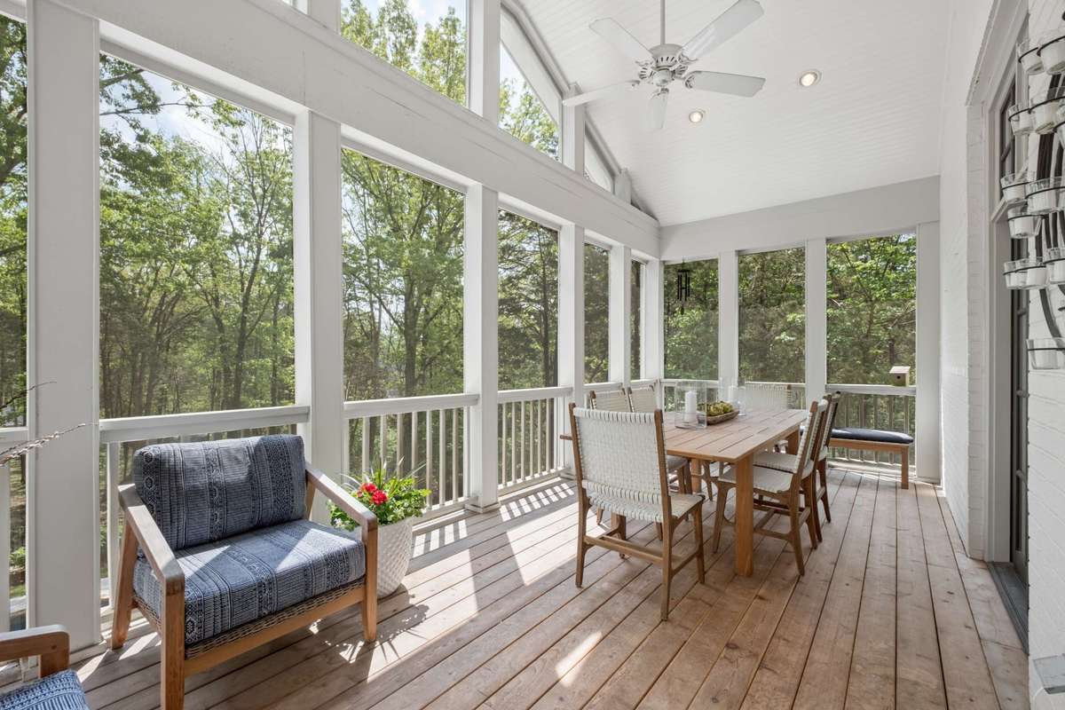French Doors off of the Kitchen lead to a peaceful Screened Porch offering additional living space for relaxing and dining outdoors.