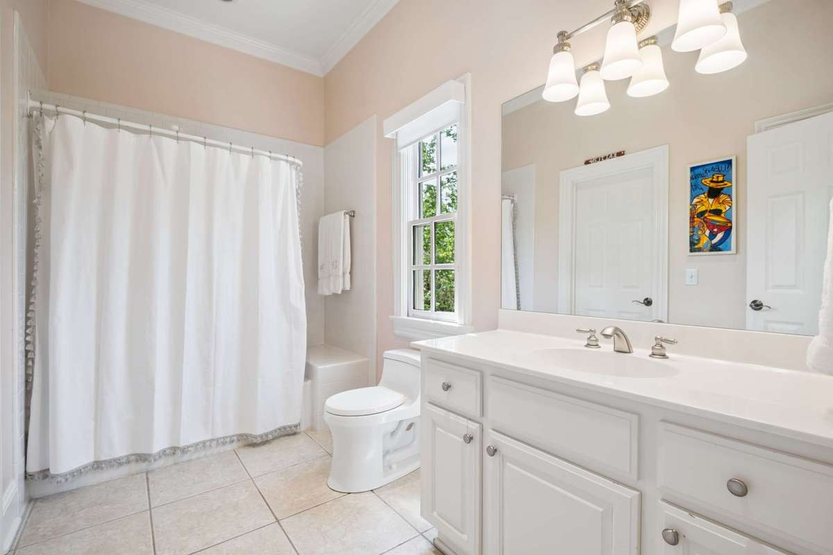 En-suite Bath for Bedroom #3 has a large vanity and a tub/shower combination.