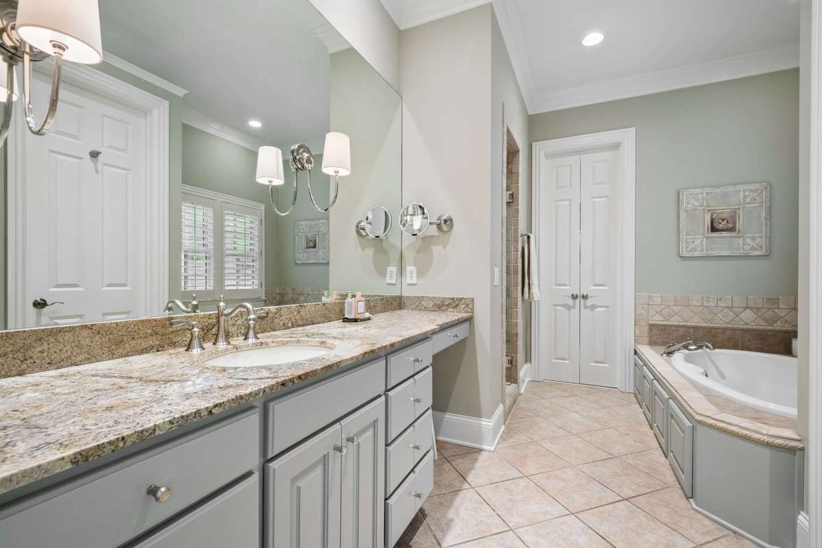 The primary suite has separate bathrooms and dual walk-in closets for added comfort and privacy. Bathroom #1 pictured here.