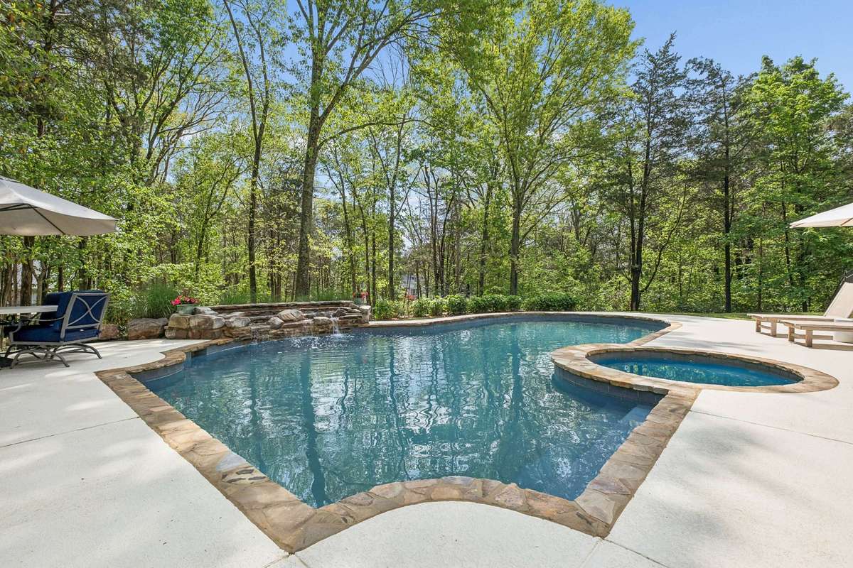 Stunning, renovated, heated saltwater pool featuring a spa and cascading waterfall, offering a peaceful, resort-inspired escape right in your backyard.