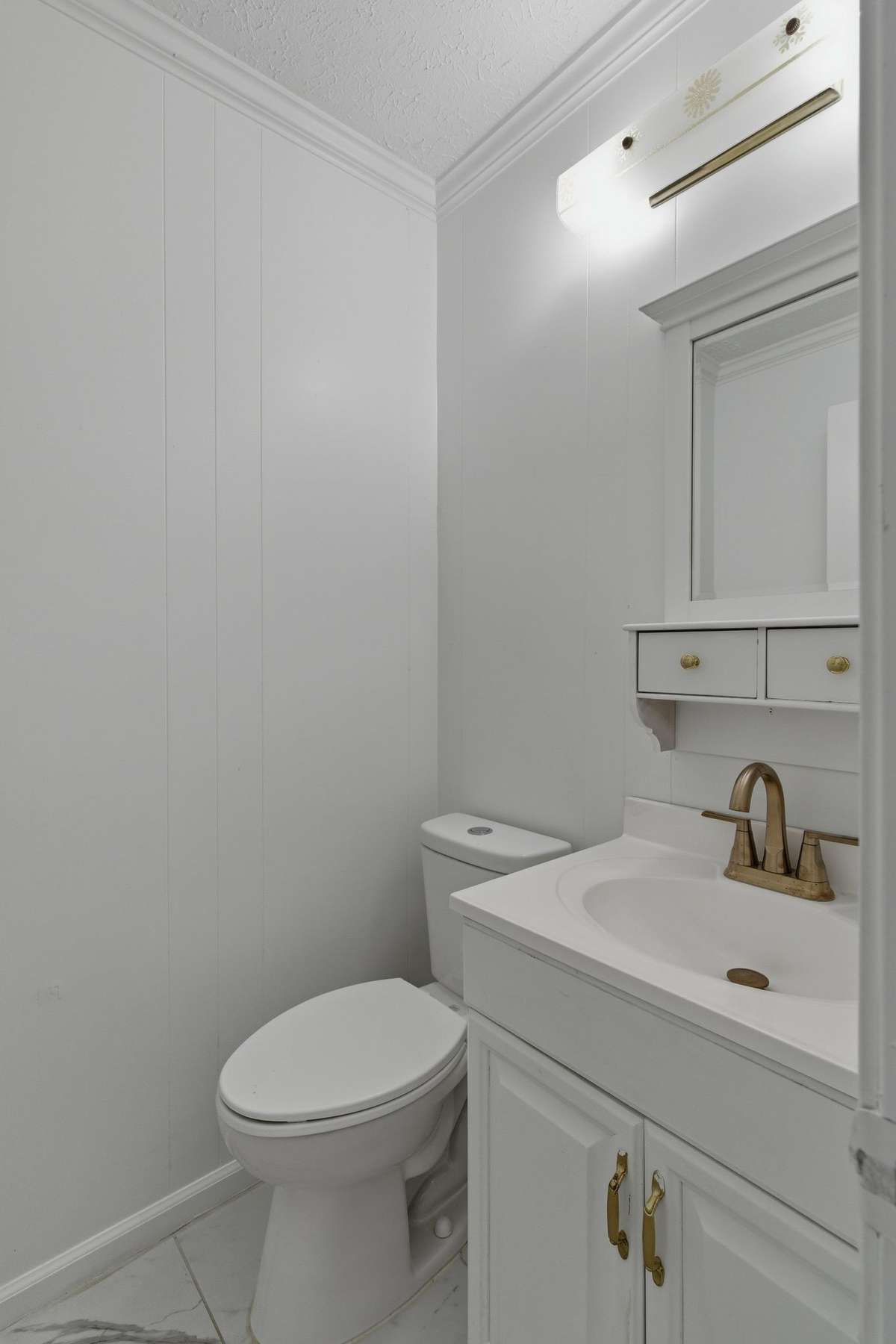 Half bath located by the entrance stairwell