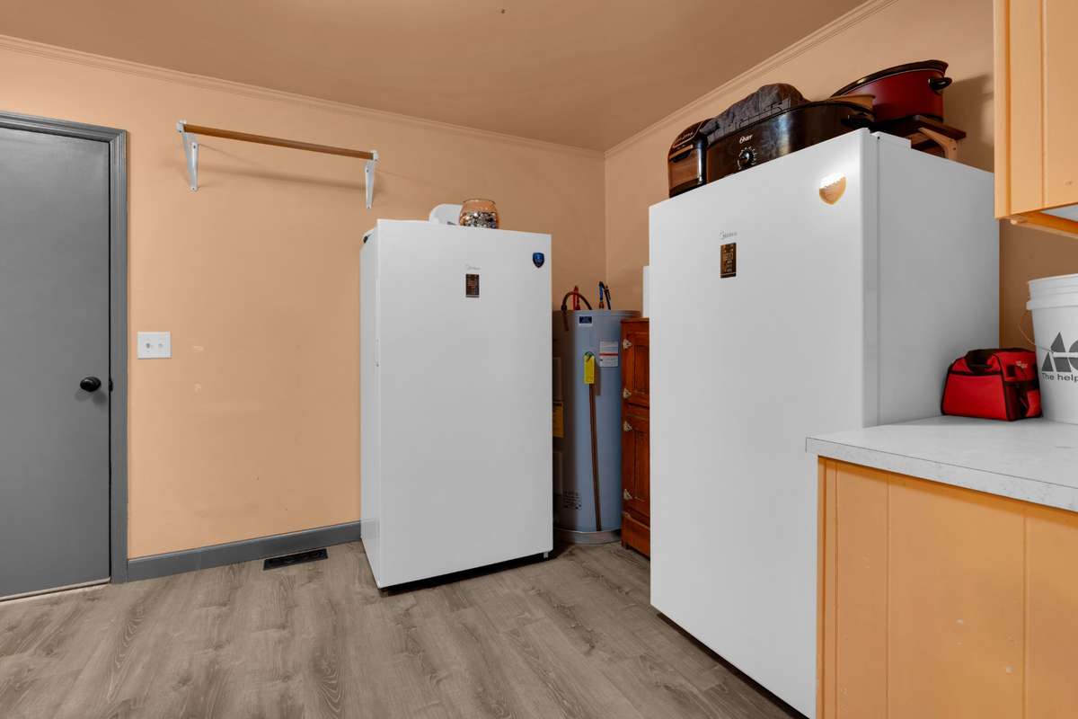 Laundry/utility room: Washer, dryer, white refrigerator, and white freezer in laundry. will not remain.