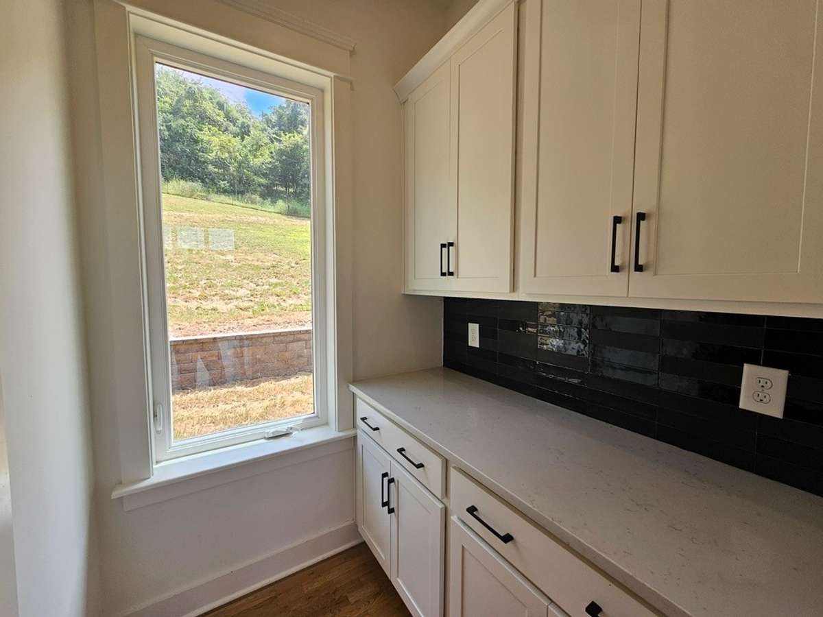 This is the butler's pantry just off the kitchen, which could also be used as a coffee station or bar. To the left of this is the walk-in pantry.