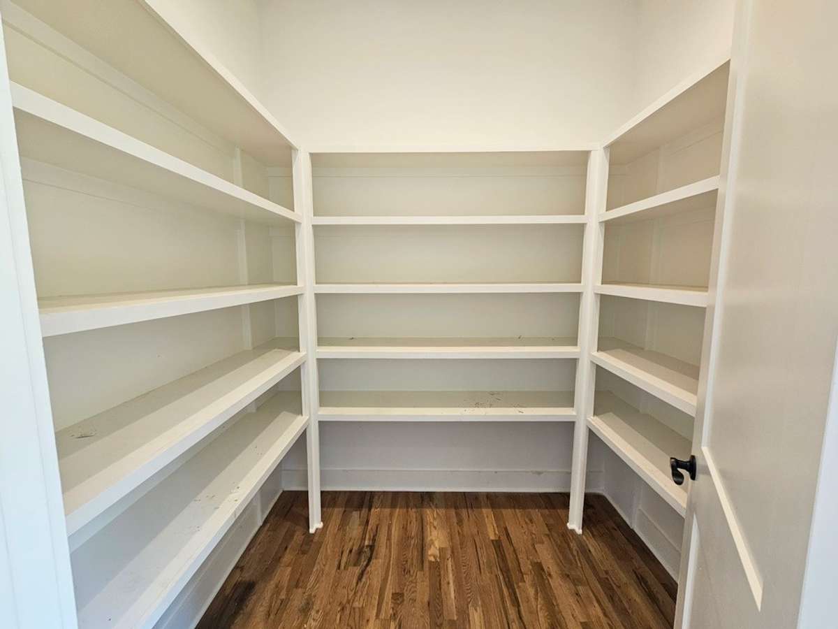 Walk-in pantry located off the kitchen and across from the butler's pantry/coffee station.