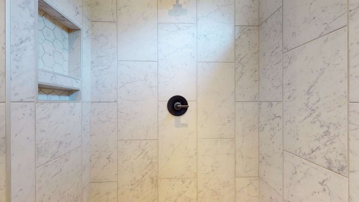 An interior view of the tiled shower.