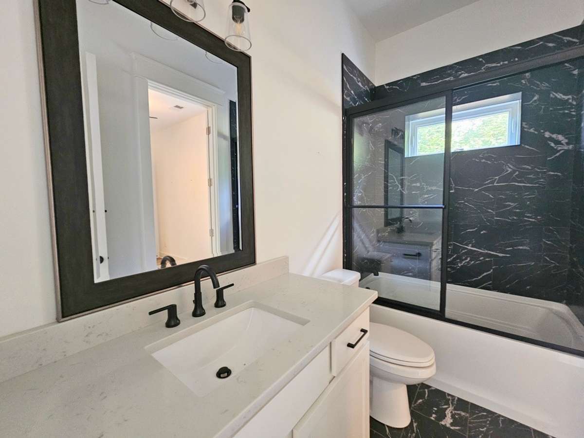 Third bathroom located on the lower level between the 3rd and 4th bedrooms.