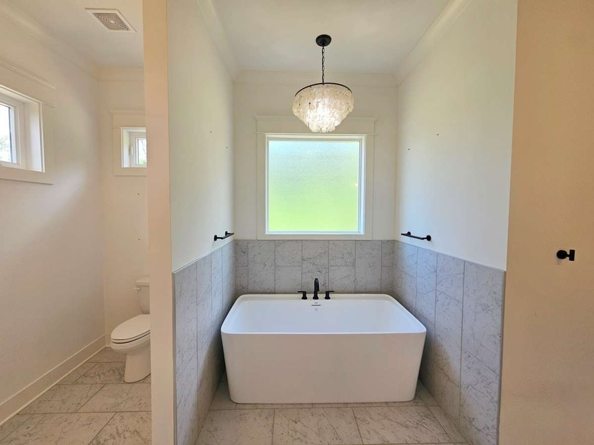En suite soaking tub in large luxurious bathroom.