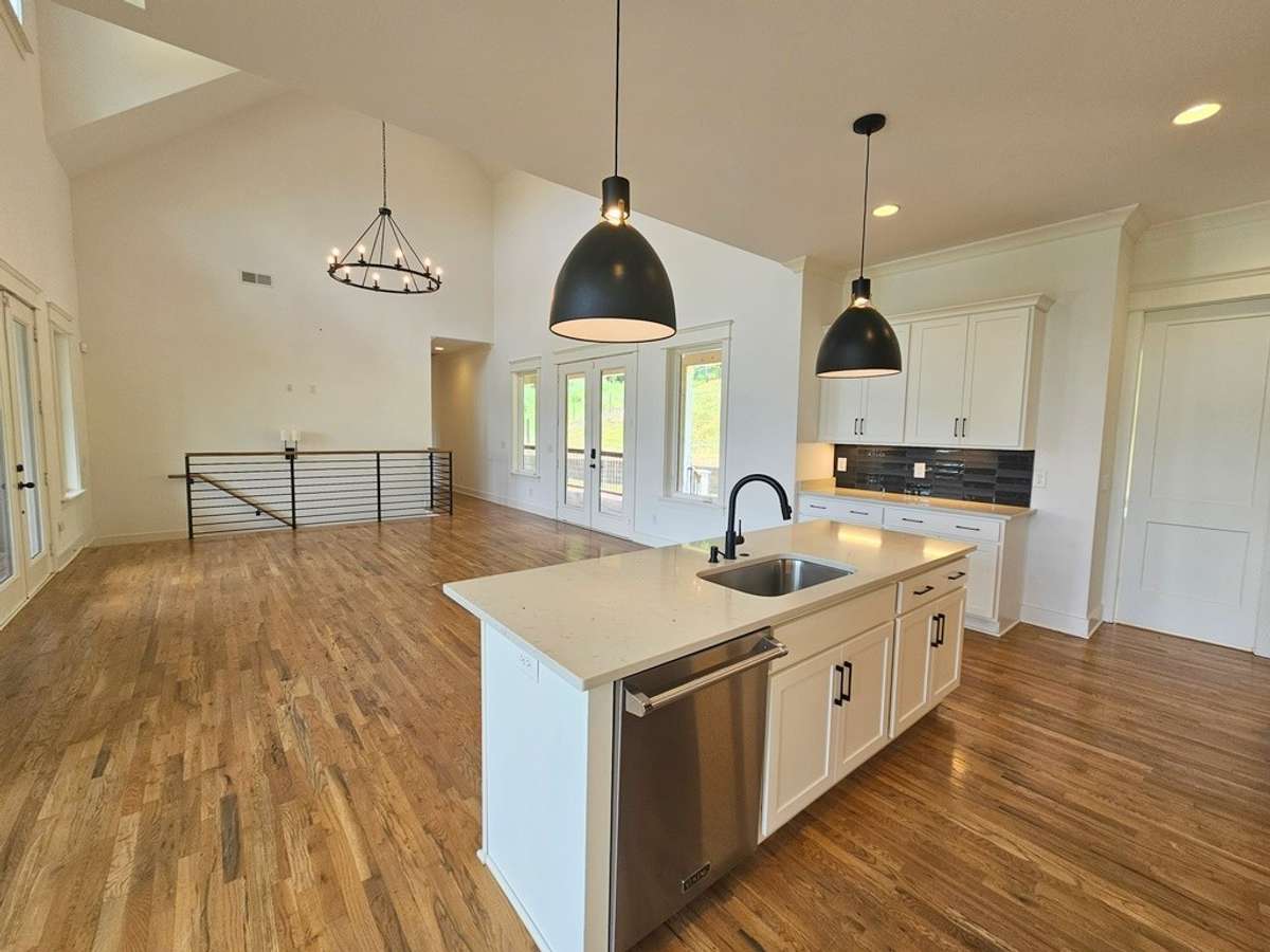 Kitchen island/breakfast bar. Deep farmhouse sink with garbage disposal and top-of-the-line stainless dishwasher.