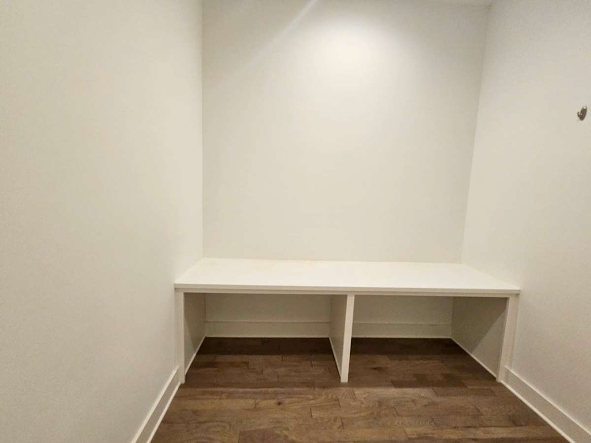 Hobby room located down the hall past the stairs on the left. This could be a gift wrapping station/craft station or office.