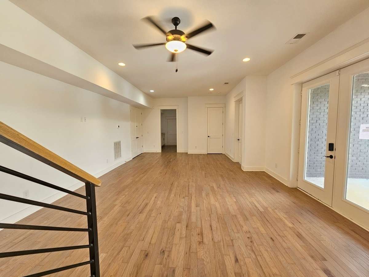 Lower level entertainment area with a small kitchen/butler's pantry located straight ahead. Ideal for entertaining guests or relaxing with the family.