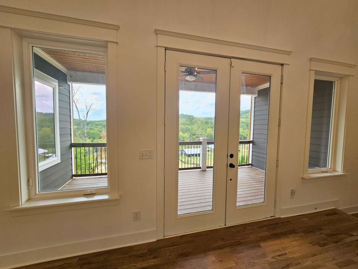 The living room windows to the front deck overlooking the front lawns and drive.