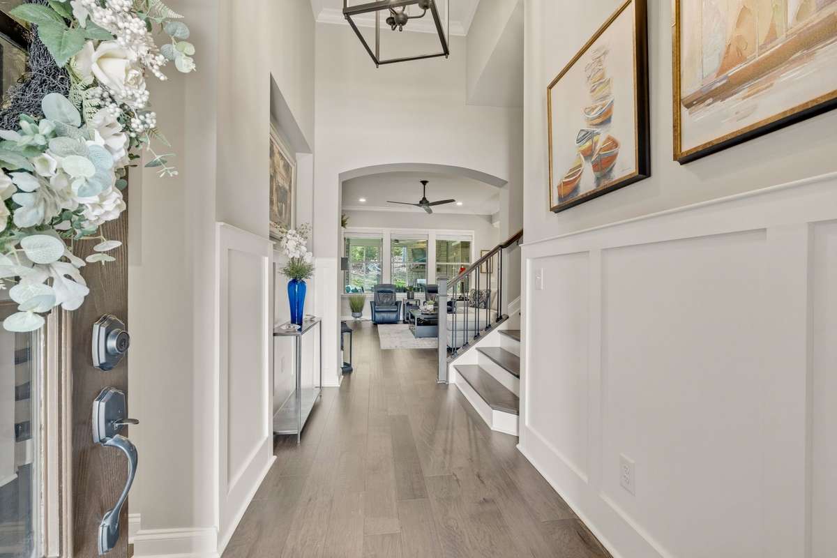 The gorgeous entry hall has soaring ceilings that give you a view straight through to your private backyard.
