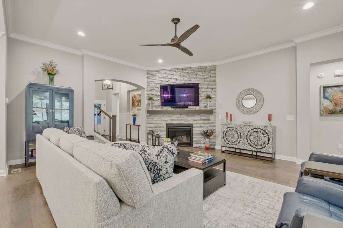 This spacious and comfortable family room is the perfect place to settle in with your impressive floor to ceiling stone facade gas fireplace.