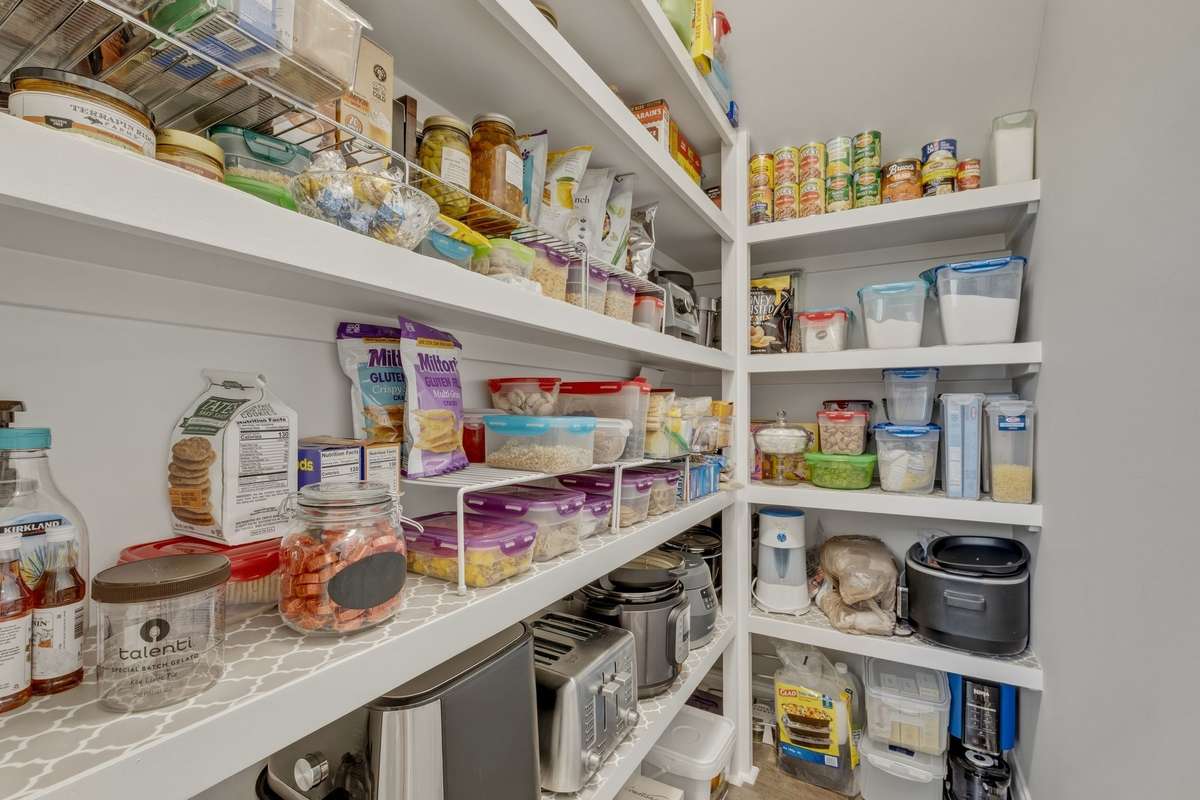 A walk-in pantry with built in shelving for even more storage space.