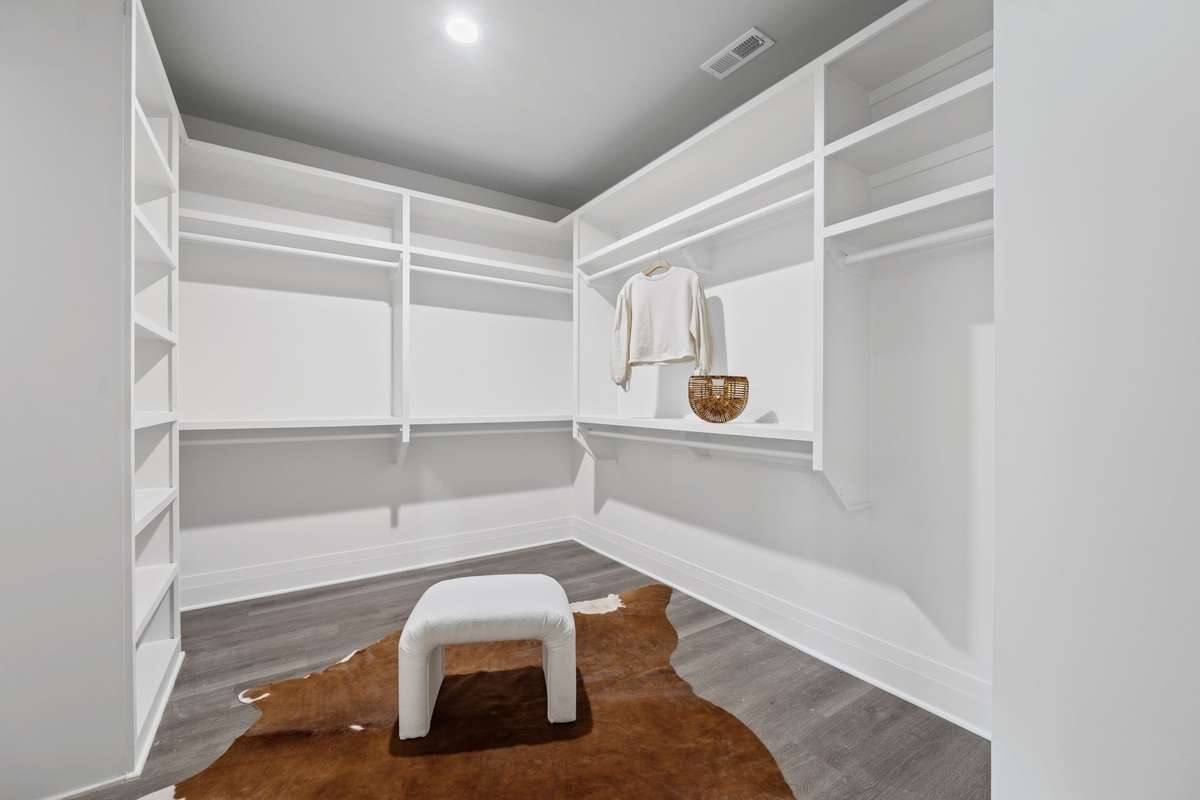 One of Two Closets in the Primary Bedroom with Custom Shelving.
