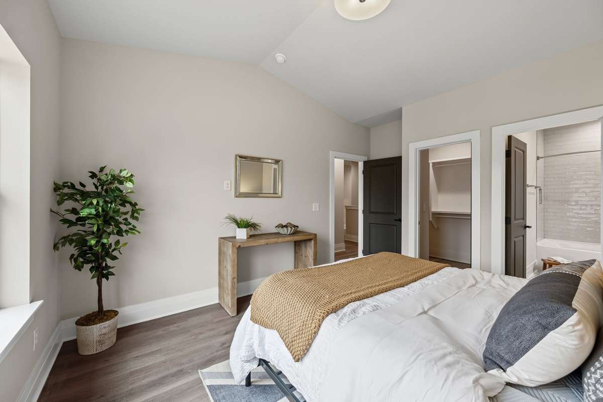 Second Bedroom with Walk-In Closet with Custom Cabinetry and Full Bathroom.