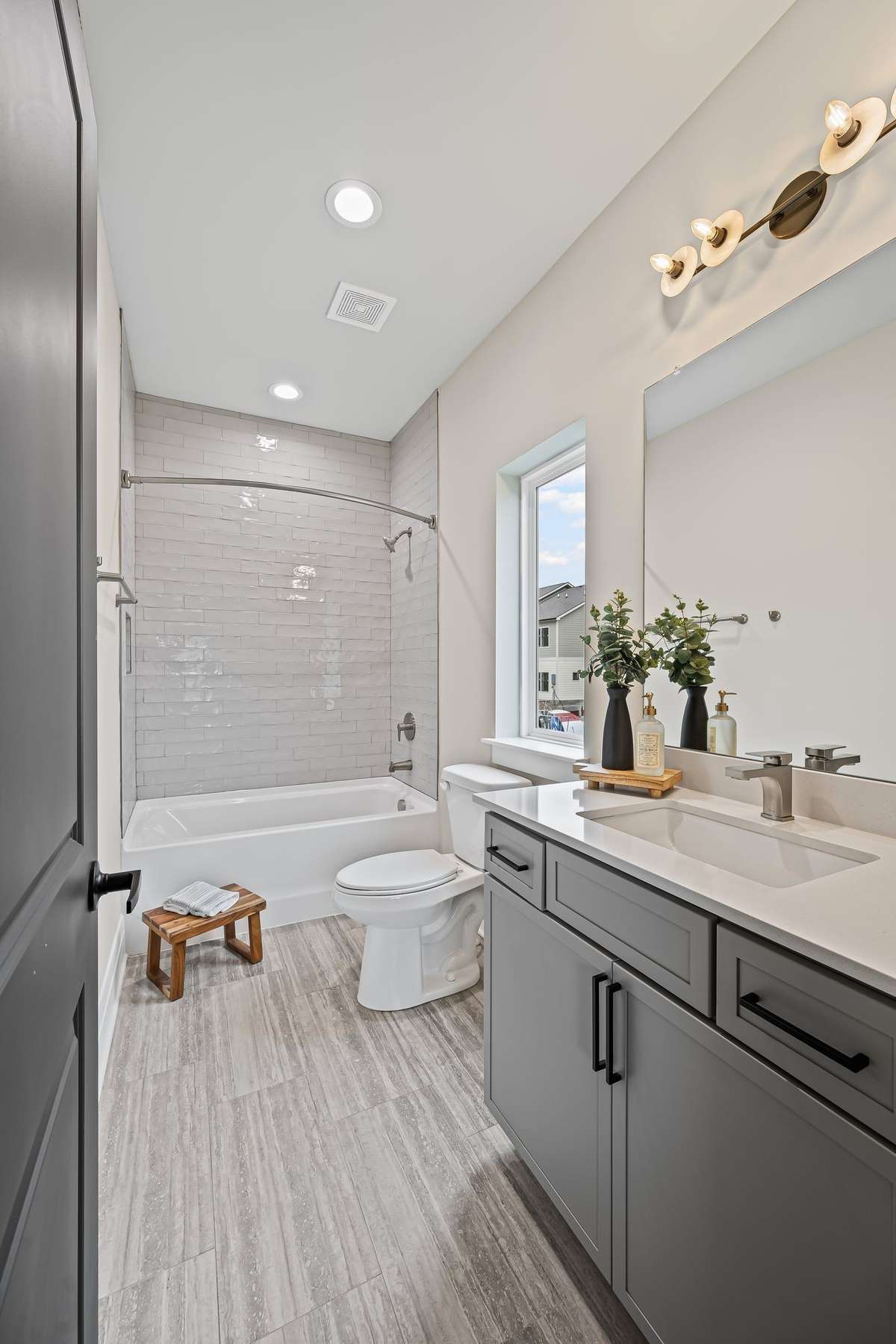 Second Bedroom Full Bath with Custom Tile from Tub to Ceiling.