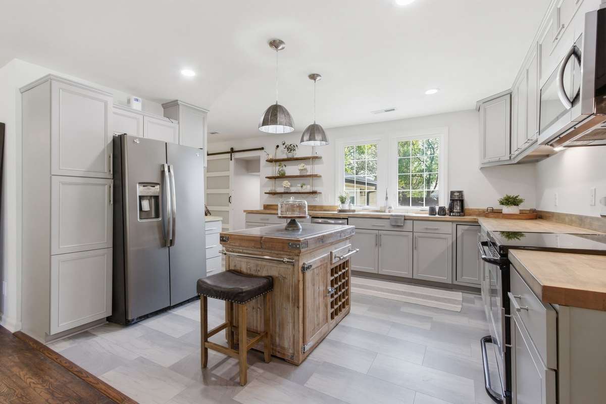 New LVT flooring in kitchen and refrigerator and island convey