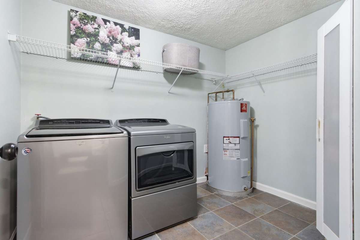 Large laundry room.  Washer and dryer convey. This side of the home has its own water heater.