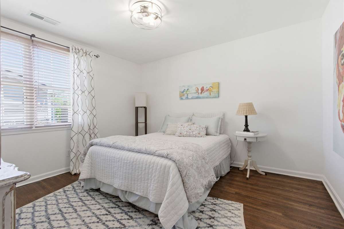 Another one of 4 bedrooms with hardwood floors and 2 windows