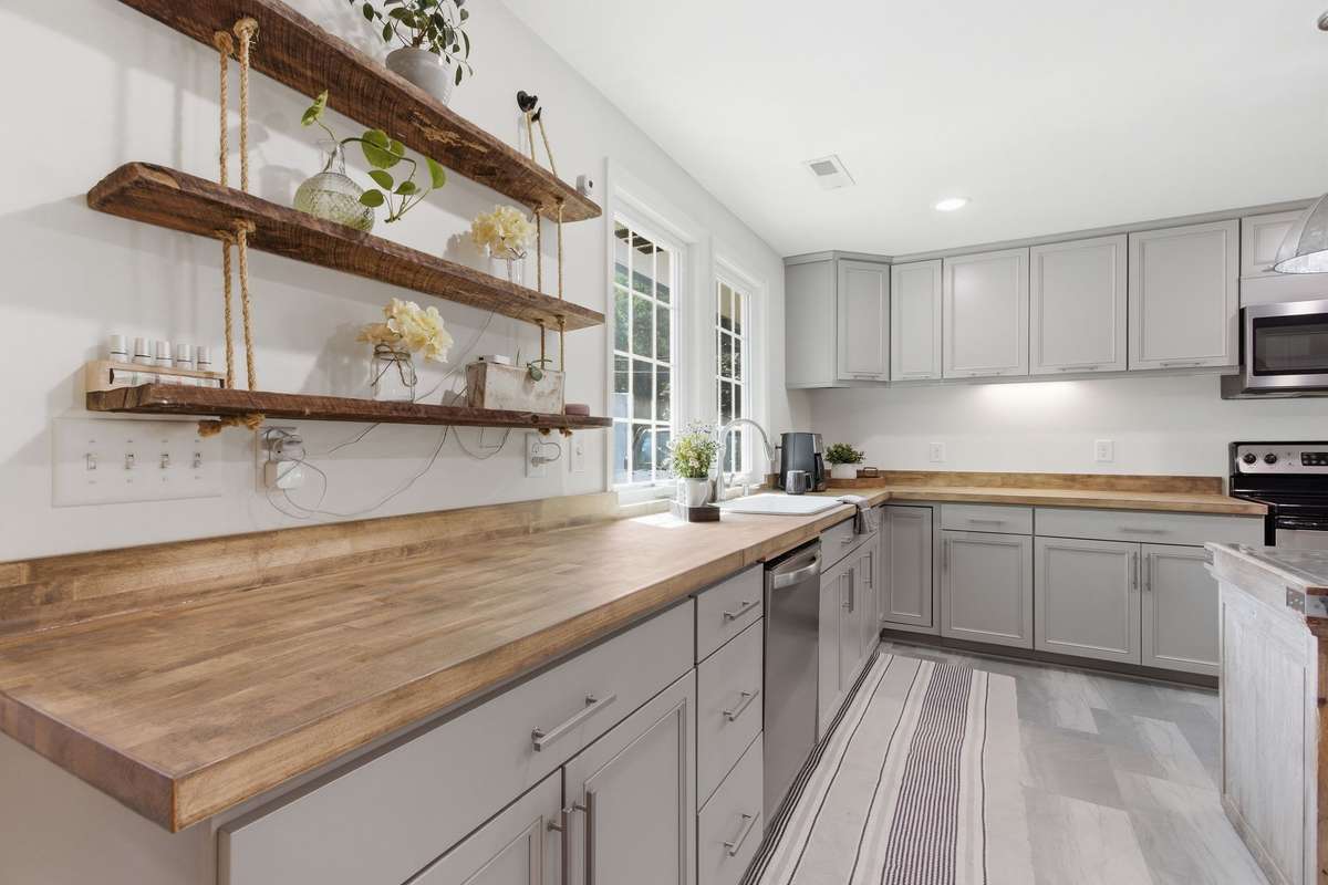 Stainless steel appliances and the sink area offers a view out the 2 newer large casement windows