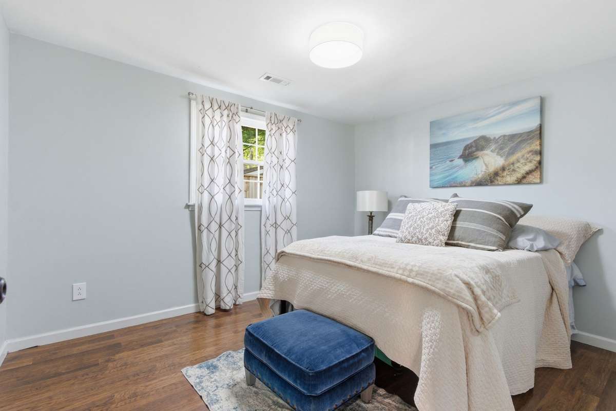 Bedroom #3 with window, new ceiling light, and LVP flooring