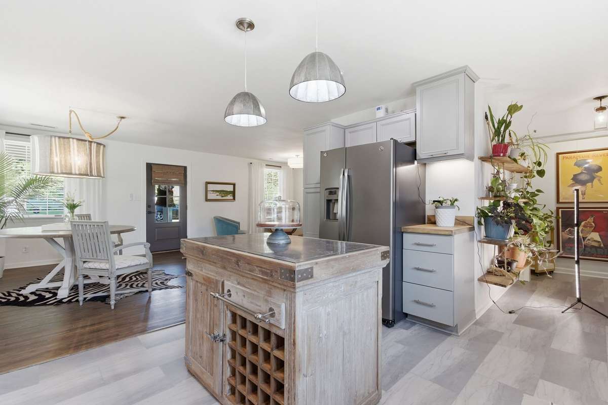 Open floor plan in kitchen, dining and living rooms.