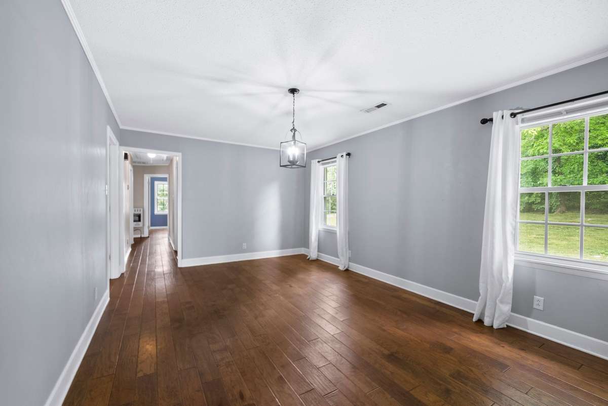 Formal dining room with a lot of natural light.