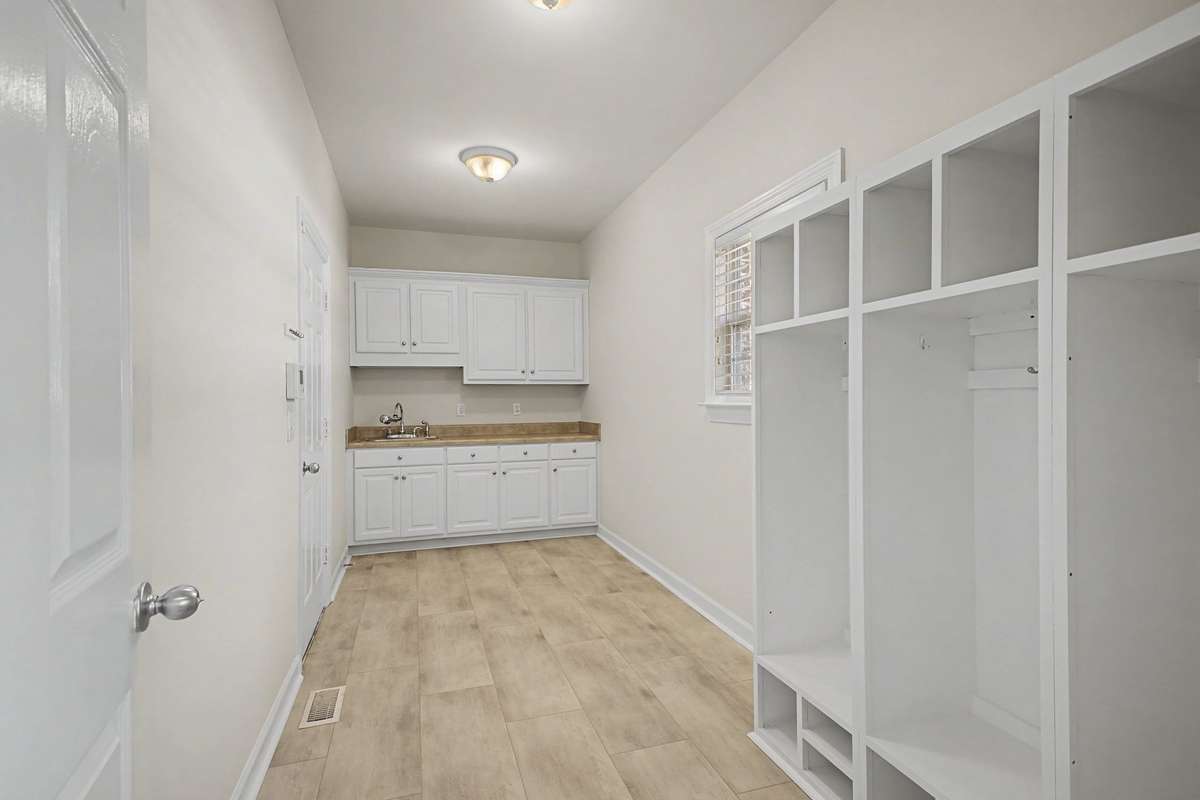 Huge Mud Room with shelving, new flooring, paint and hardware