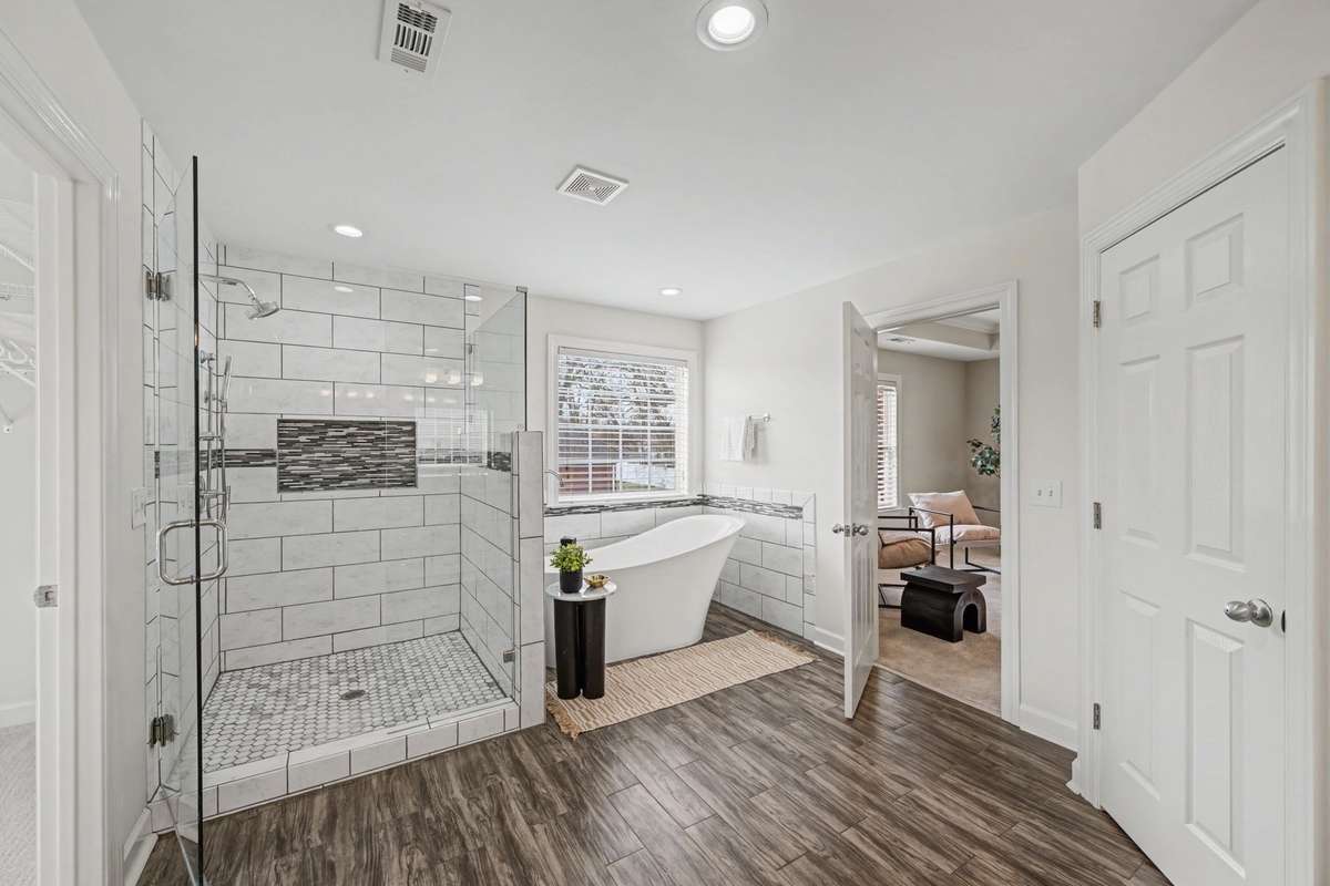 Entry to owners suite with spa like Large Soaking Tub and walk-in shower tiled to the cielling