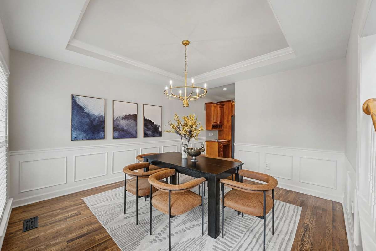 Formal dining room just off the kitchen, beautifully updated with new hardwood floors, fresh paint, & an updated light fixture. Surrounded by multiple windows, the space is filled with natural light, creating a bright and elegant setting for dining