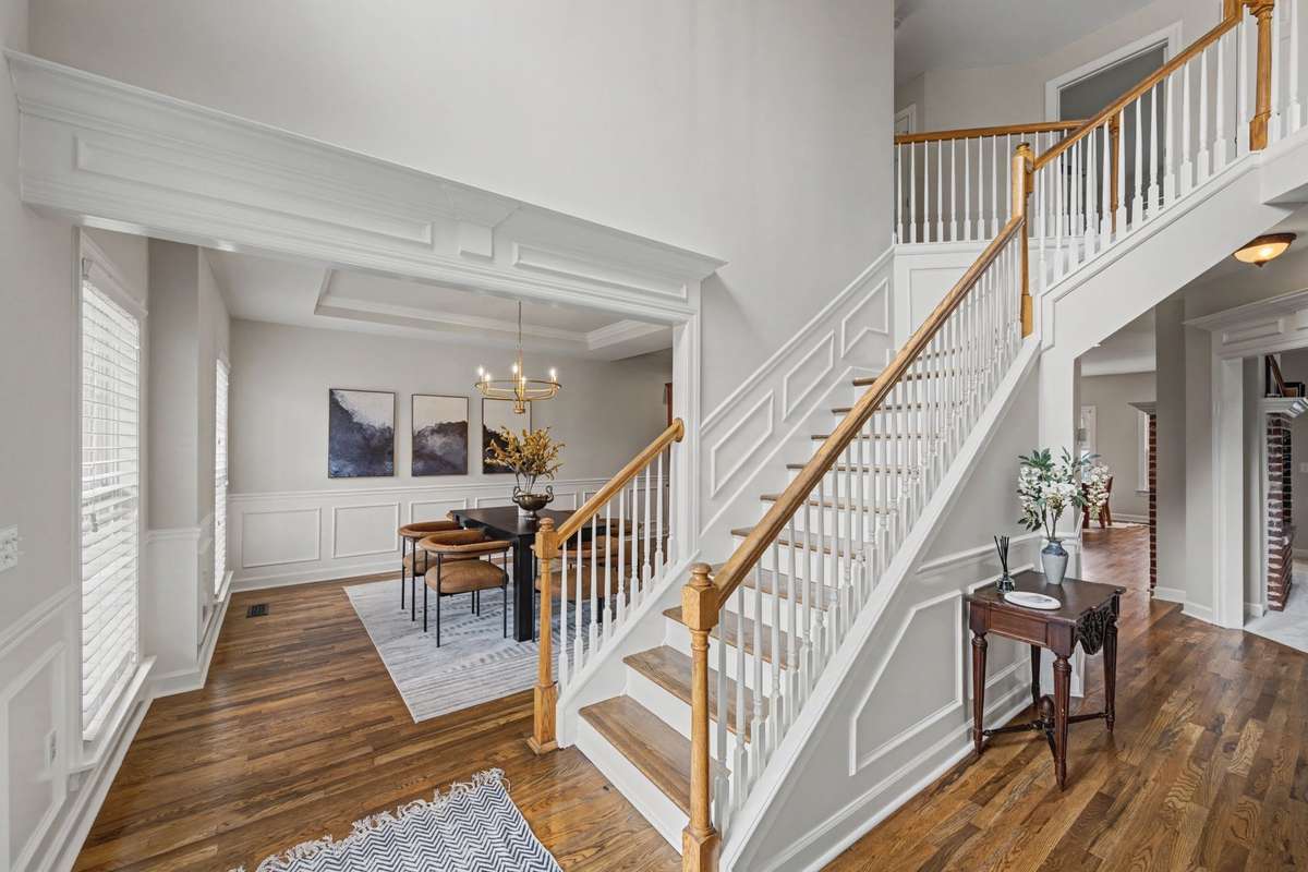 Entry capturing the new hardwoods, detailed trim work & natural light to dining room