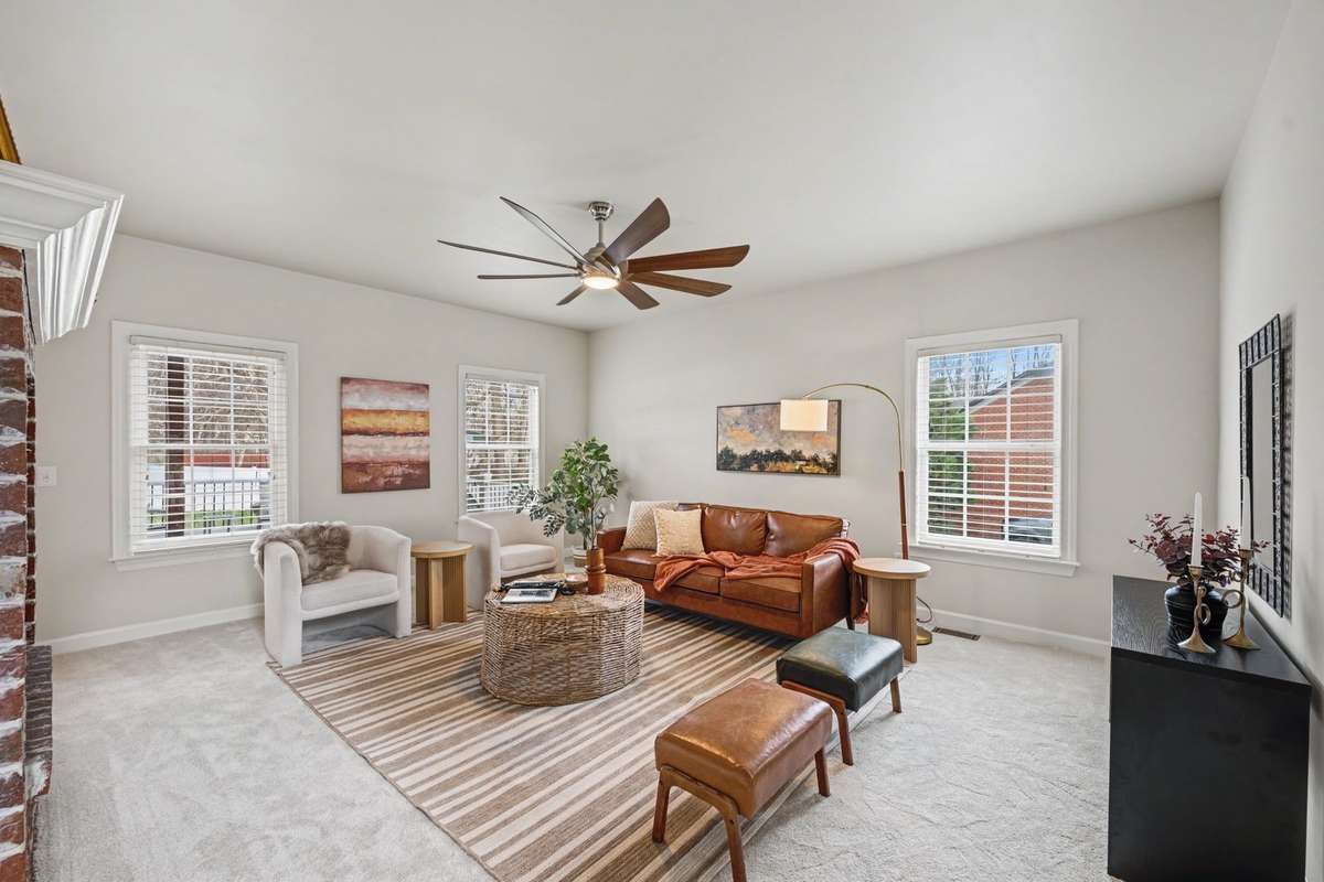 Den/Living Room with fireplace, new flooring, fixture and paint.