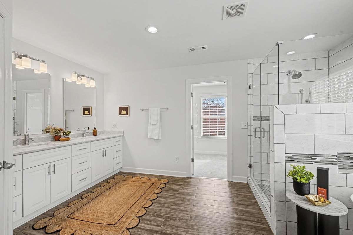 Double vanity with granite, new paint fixtures and entry to your large walk-in owners suite closet