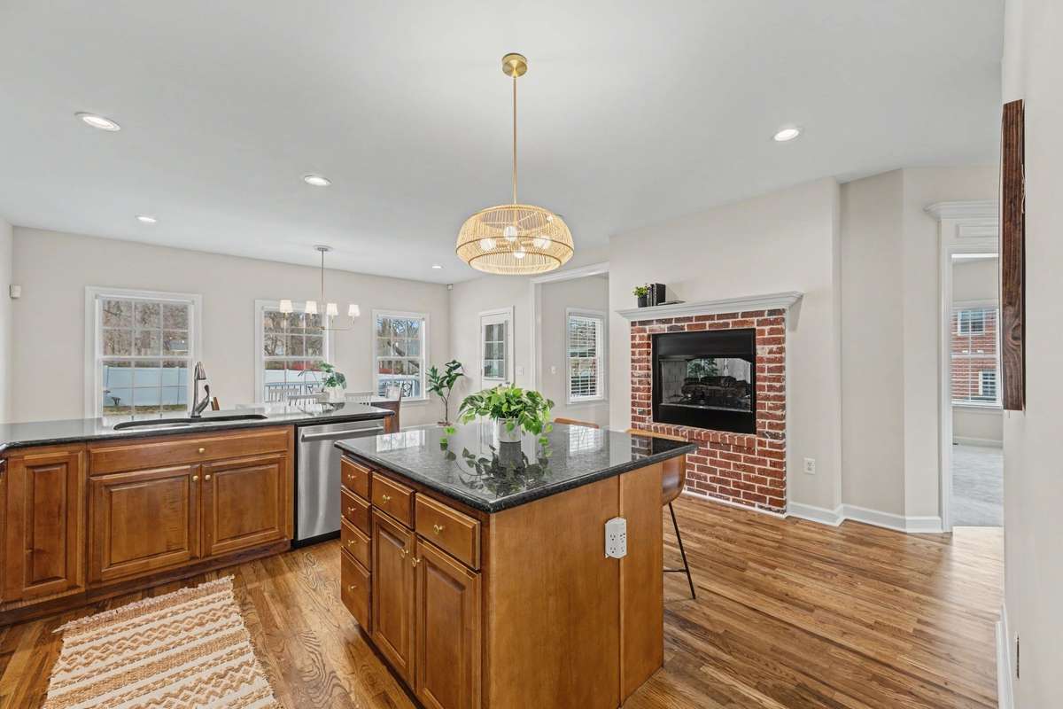Showing off the gas double sided fireplace and new hardwoods, paint and fixtures