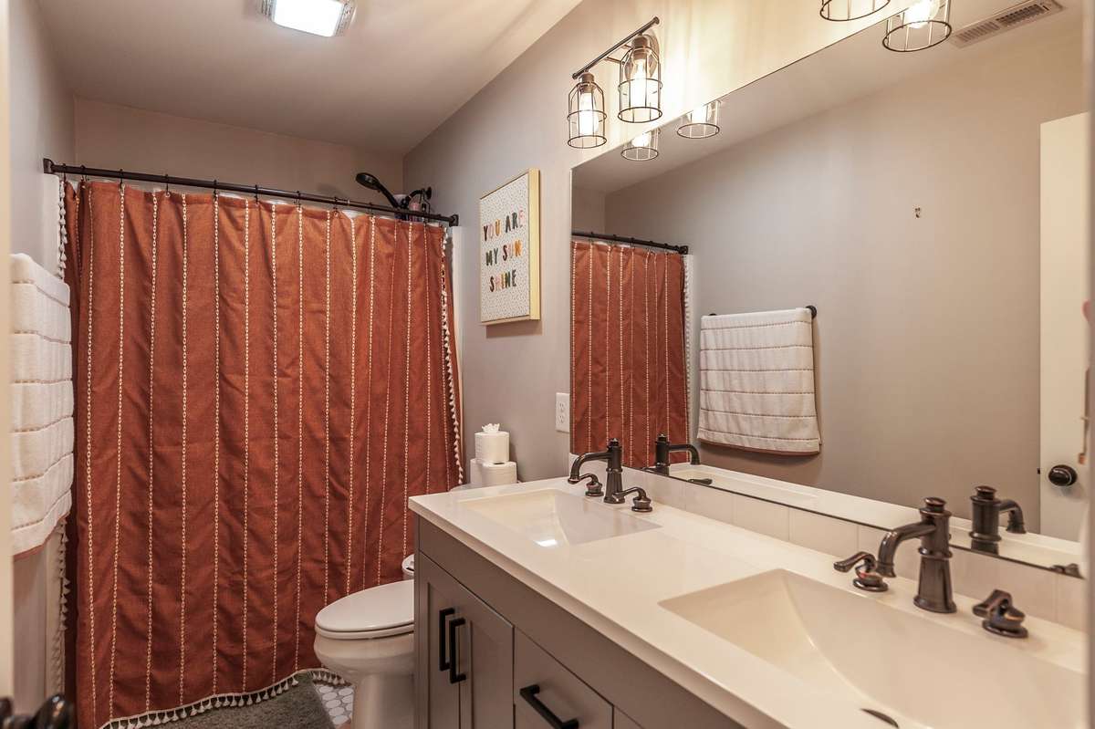 The hall bathroom features a double vanity sink.