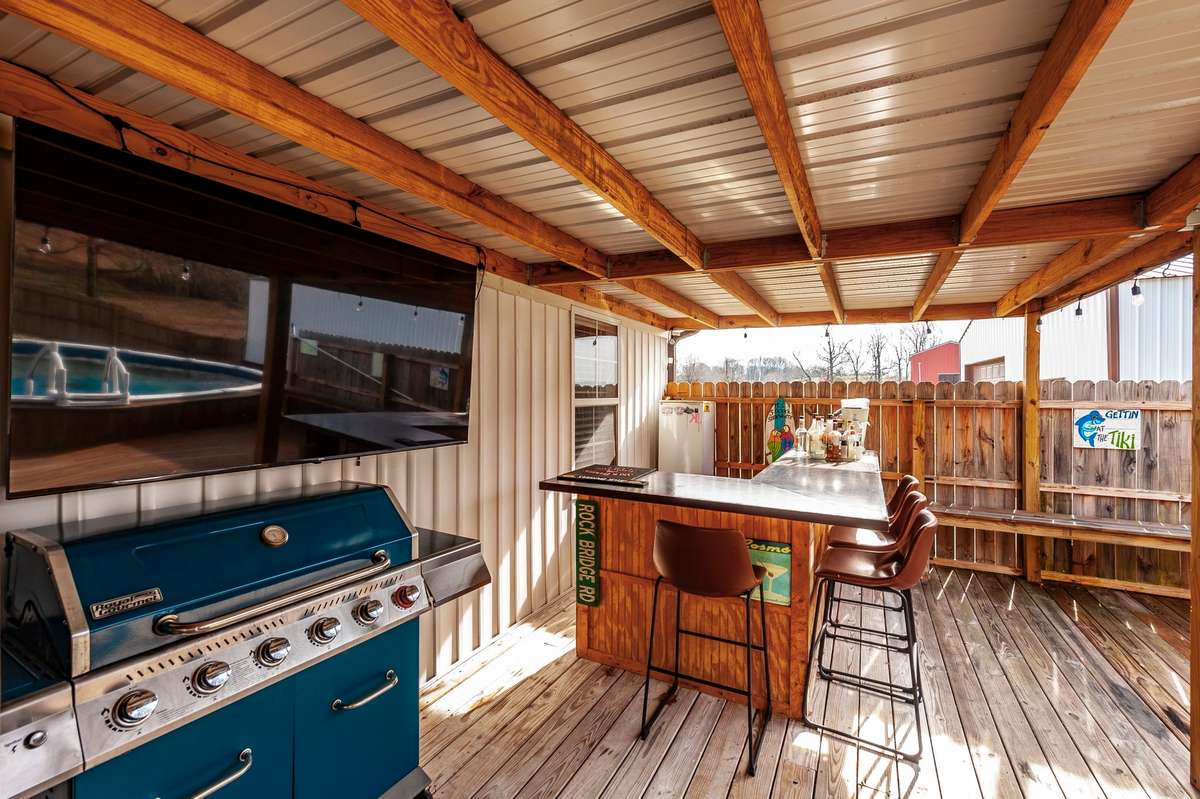 Check out this covered deck with your own bar area which will be perfect for entertaining while your guests are enjoying the pool!