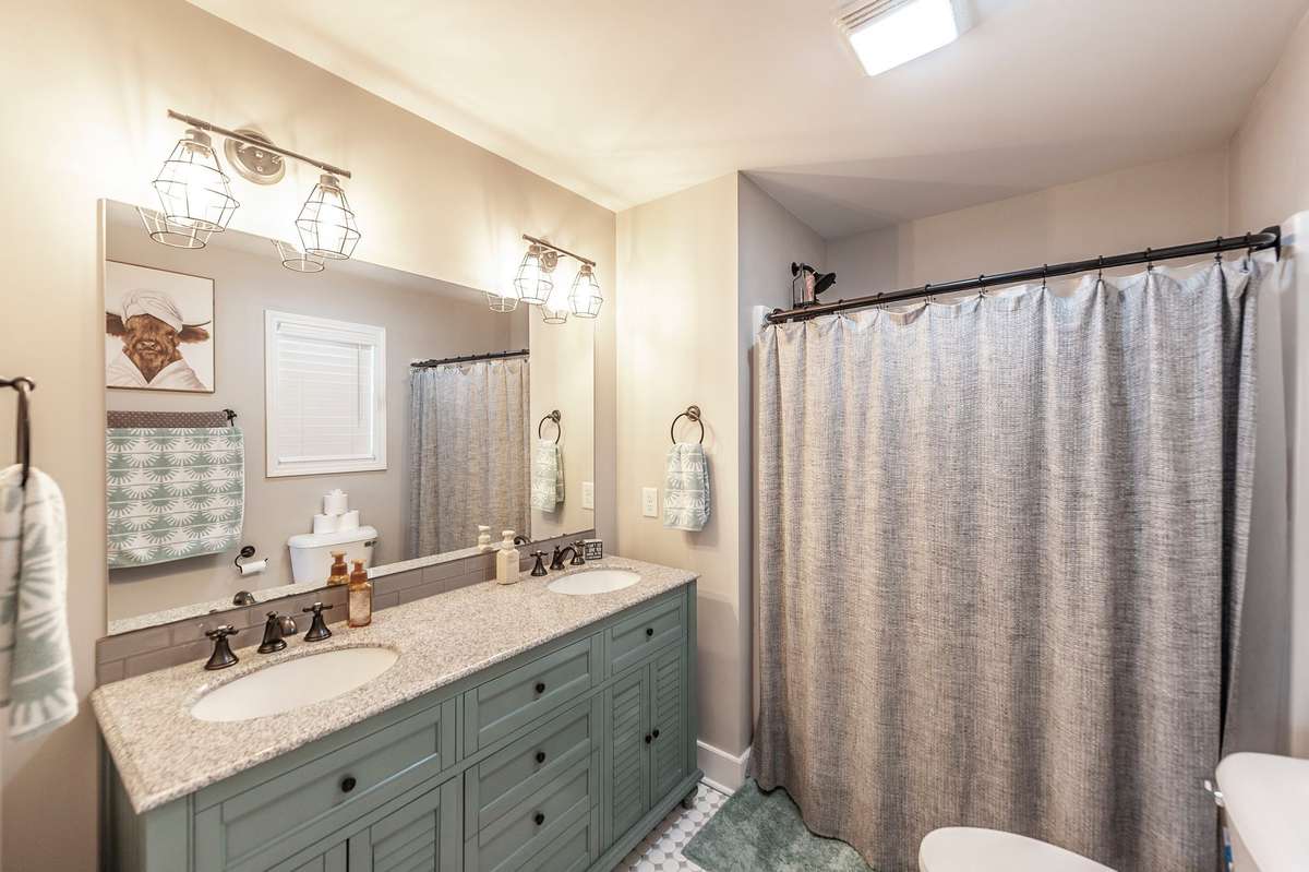 The primary ensuite features a double vanity and tile floors.