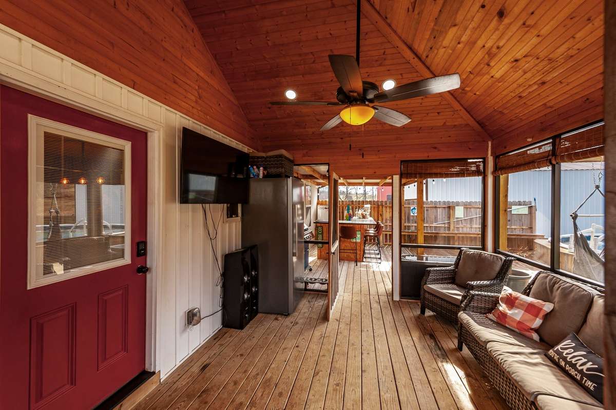 Sit back and relax on your 12x16 screened in back porch.  The television remains with the property.