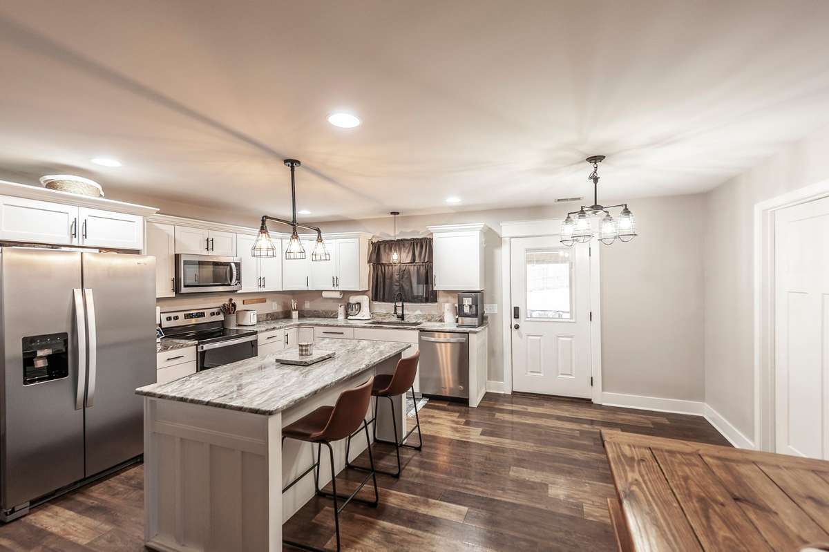 Your new kitchen features granite counter tops, stainless steel appliances, and lots of cabinetry for storage.