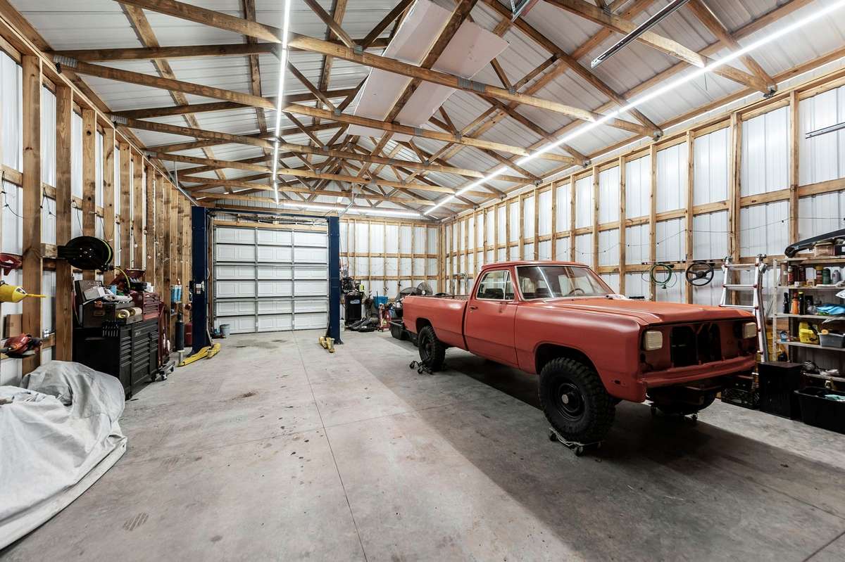 30x50 garage with 14 ft tall walls big enough for your dump truck or RV.  This garage has a separate 200-amp meter with 220 wiring.  The Lift stays with the property!