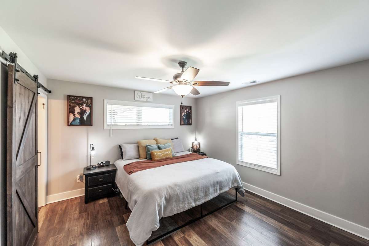 The spacious primary suite is a true retreat, featuring abundant natural light and a large walk-in closet.