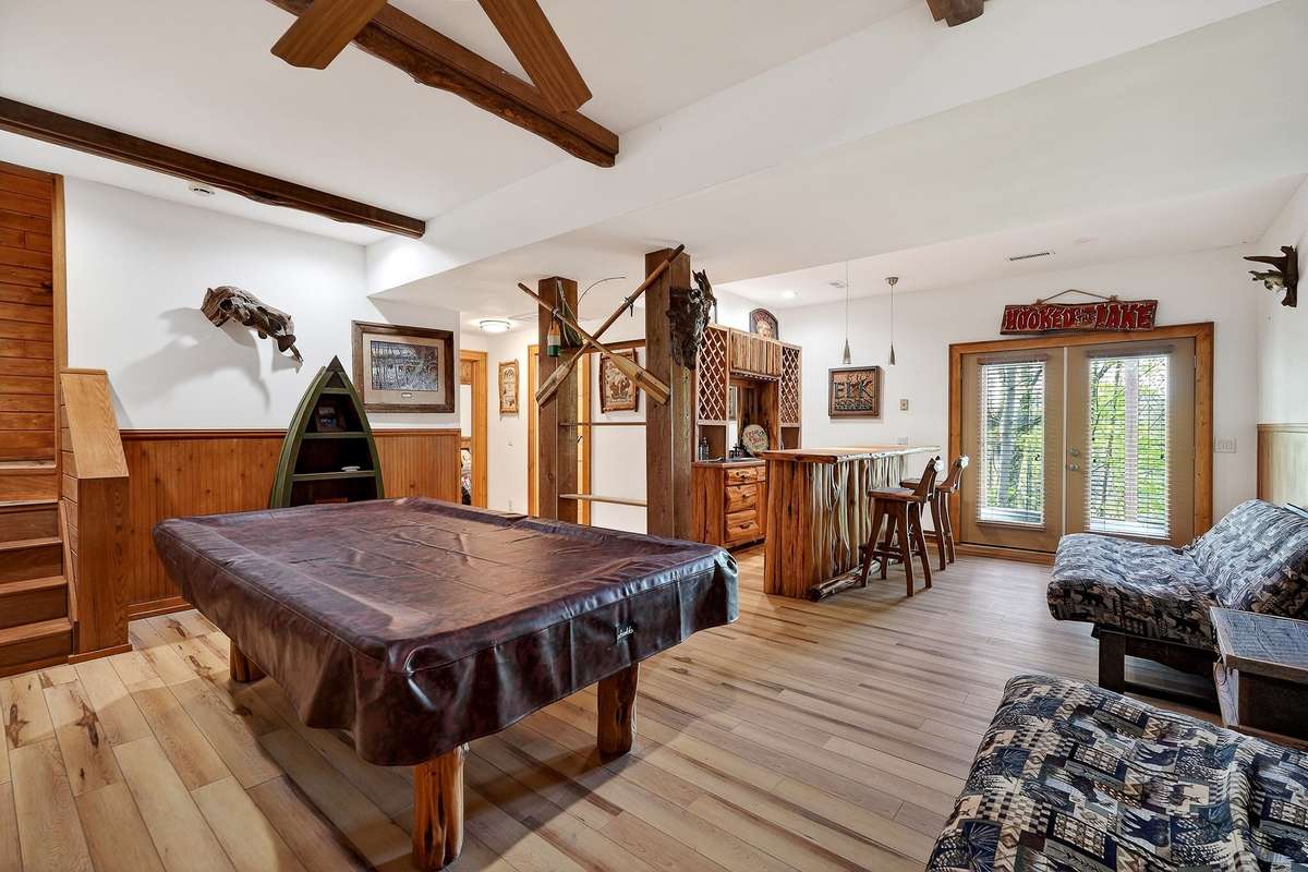 Walkout basement game room. Pool table stays
