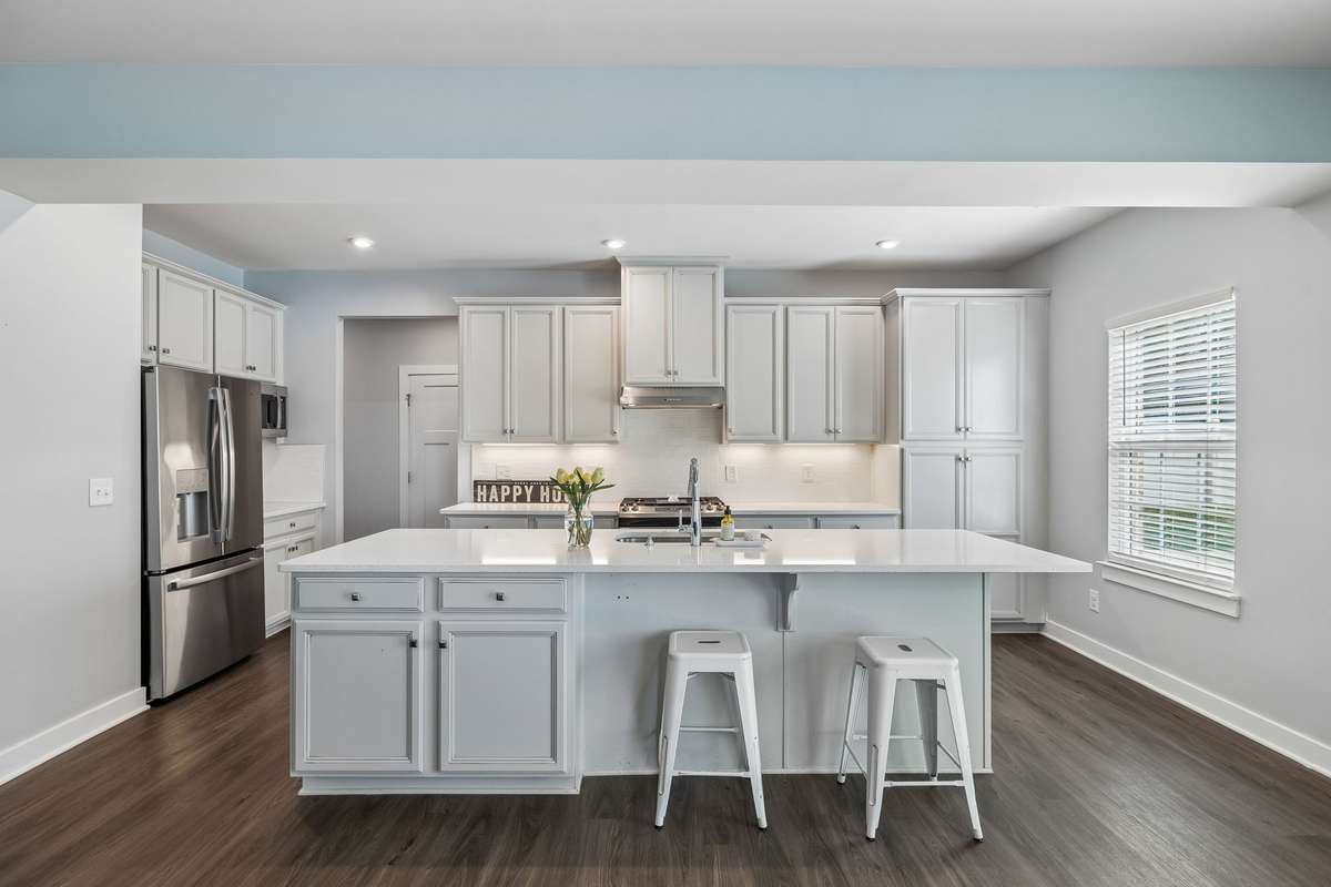 Large kitchen with a huge island w/seating, plenty of counter space, and storage.