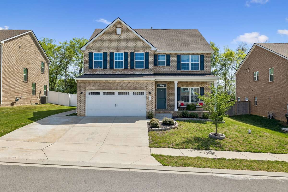 Notice the wide parking area with a sidewalk leading to the back yard as well.