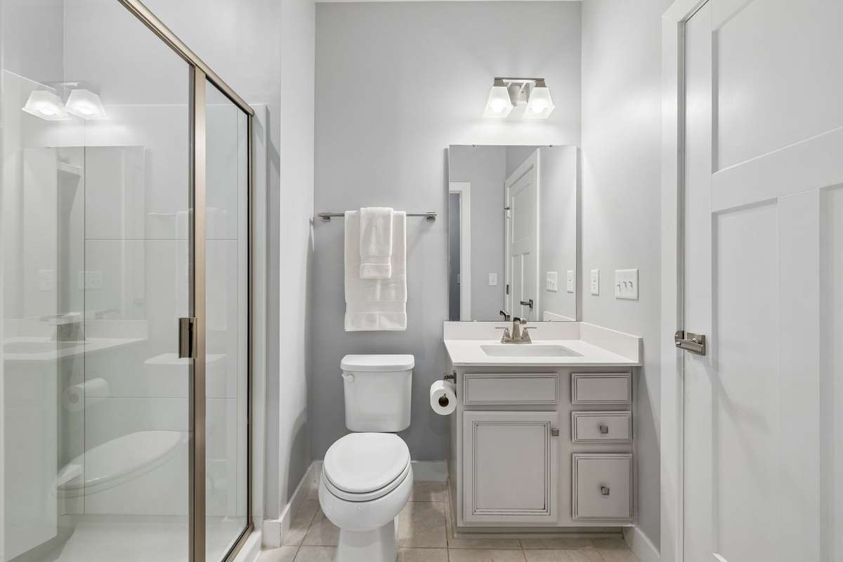 Main Floor Bath with a walk-in shower and tile floor.